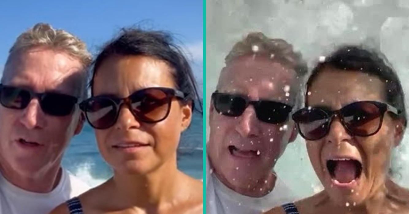 Koppel wordt op hilarische manier bespat en omver geworpen door enorme golf tijdens een video-opname